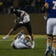 UAlbany's linebacker Dylan Kelly (42) jumps over SDSU player on Friday, Dec. 15, 2023 at Dana J. Dykhouse in Brookings.